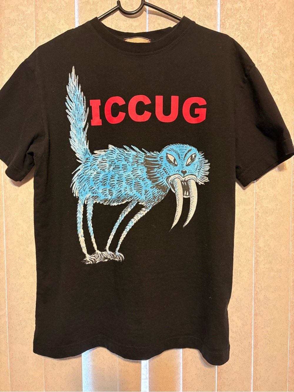 Mens Black Graphic Tee with Blue Creature and Red Logo